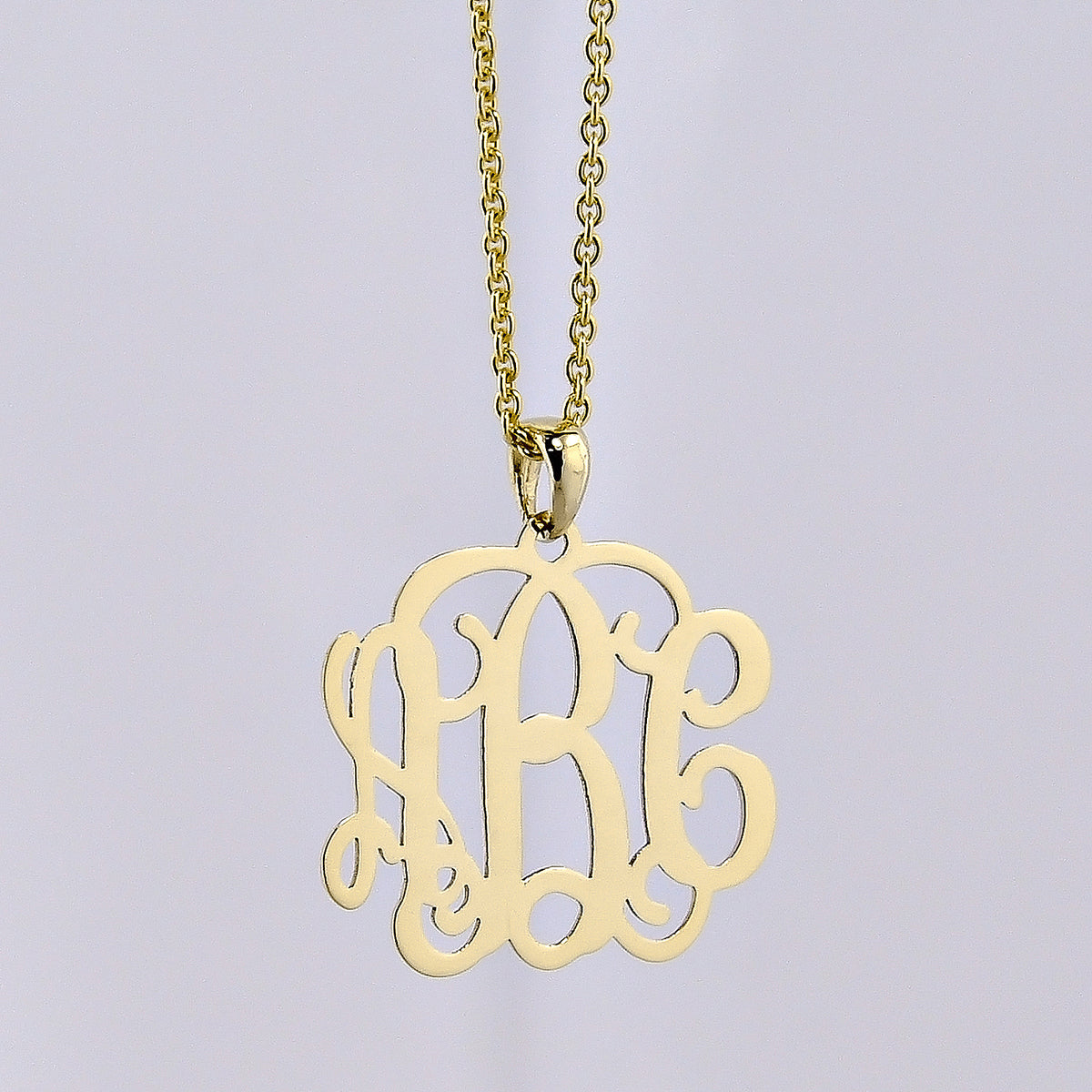 Back view of mini 3-initial monogram pendant showing authentic solid gold quality stamp.