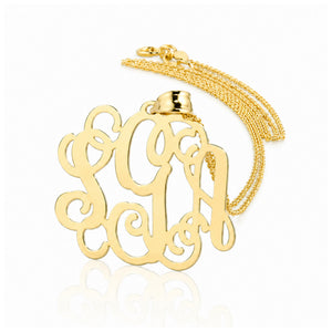 Solid yellow gold three-initial custom monogram pendant on a fine chain.