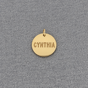 Solid white gold personalized round disc charm pendant laser engraved with the name Cynthia.