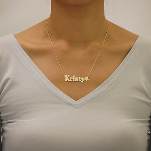 Woman wearing a custom solid gold star nameplate pendant necklace handcrafted in Los Angeles.