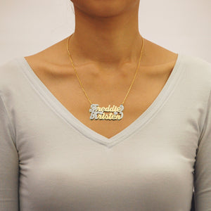 Side view of the 3D double-layered solid gold couple name pendant showing top and bottom plate thickness.