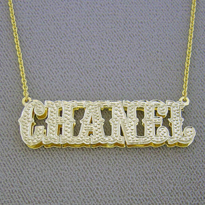 Side view detail of custom 3D double plate solid gold nameplate showing layered depth and rhodium diamond cutouts.