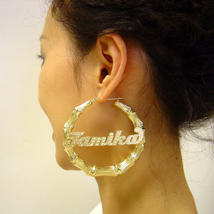 Model wearing 3 inch 10K gold personalized bamboo door knocker hoop earrings