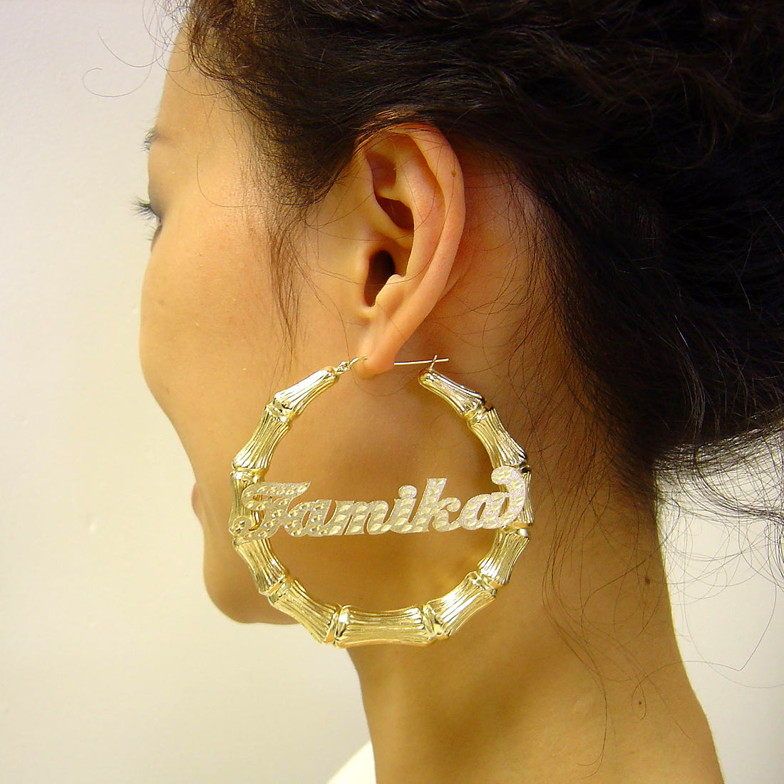 Model wearing 3 inch 10K gold personalized bamboo door knocker hoop earrings