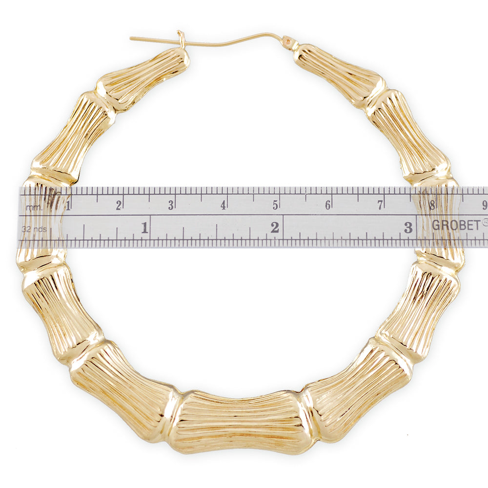 Close up of 10k gold bamboo texture pattern and latch closure on hoop earrings