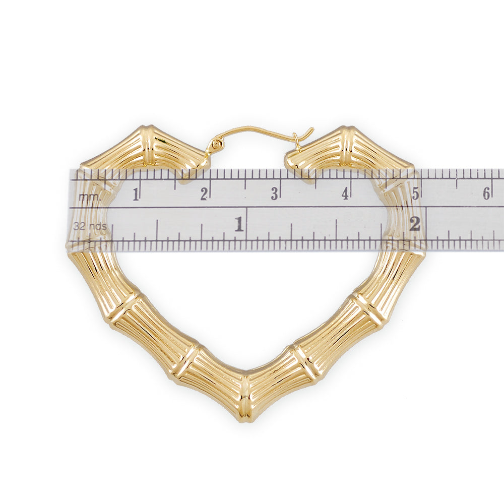 Close-up of secure clip-top huggie snap closure on real gold bamboo heart hoop
