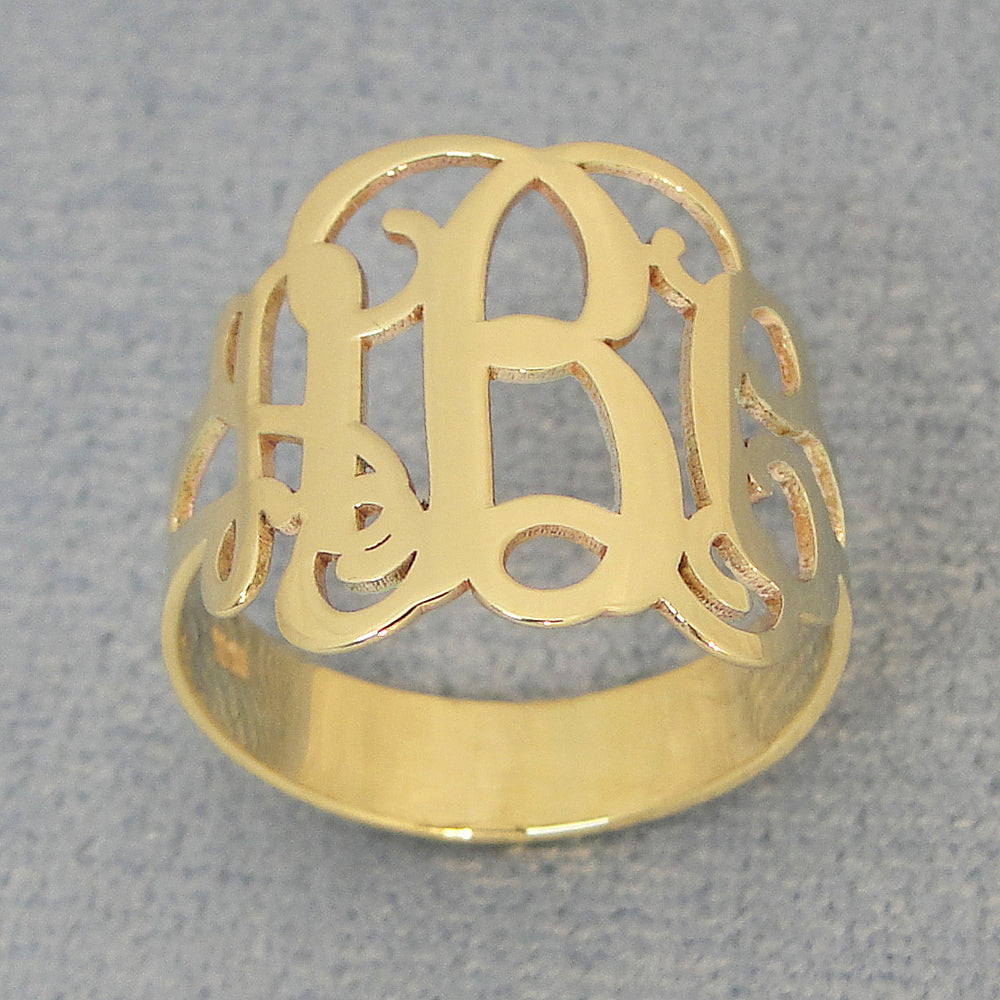 Close-up detail of solid gold script monogram ring center initial