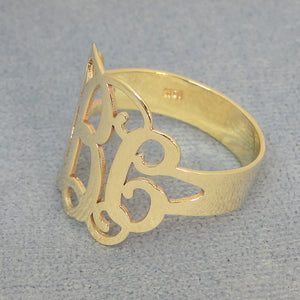 Side view of custom gold monogram ring highlighting band thickness and polish