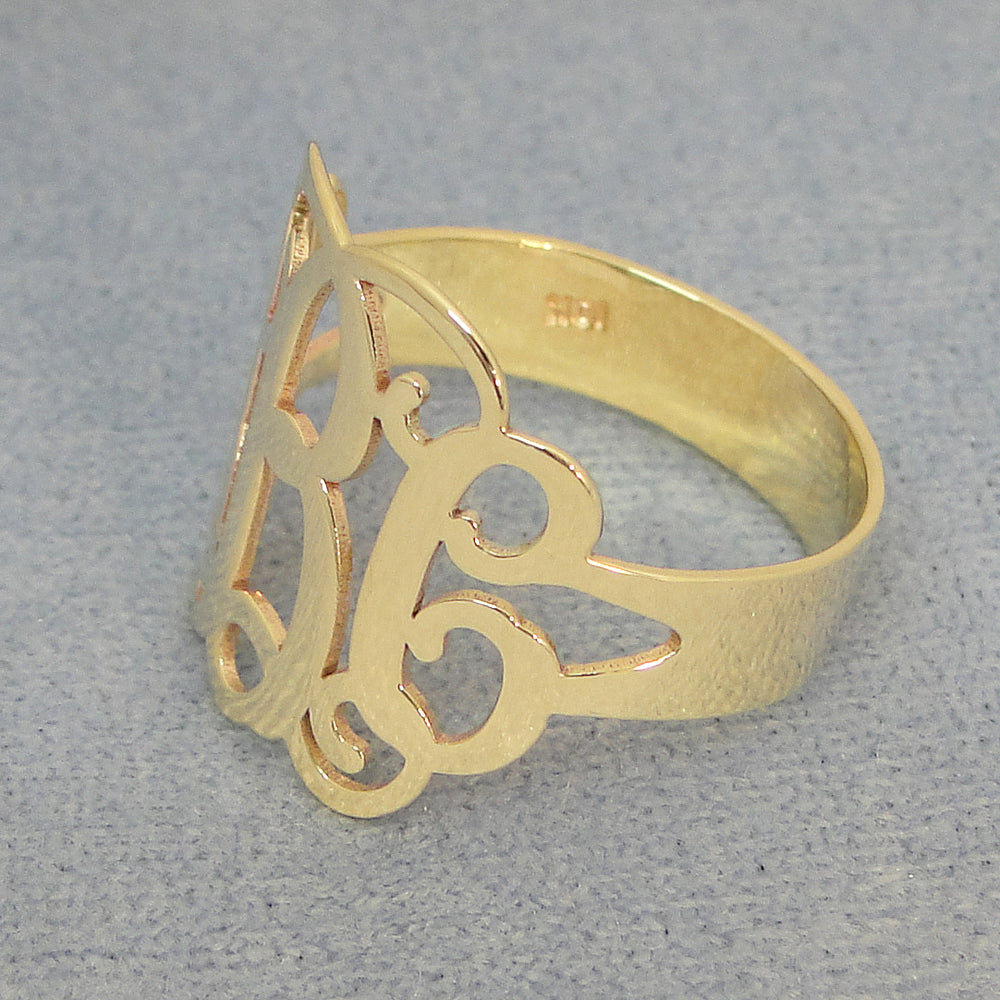 Side view of custom gold monogram ring highlighting band thickness and polish