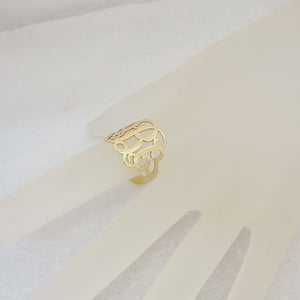 wearing personalized solid gold 3-initial monogram ring on finger