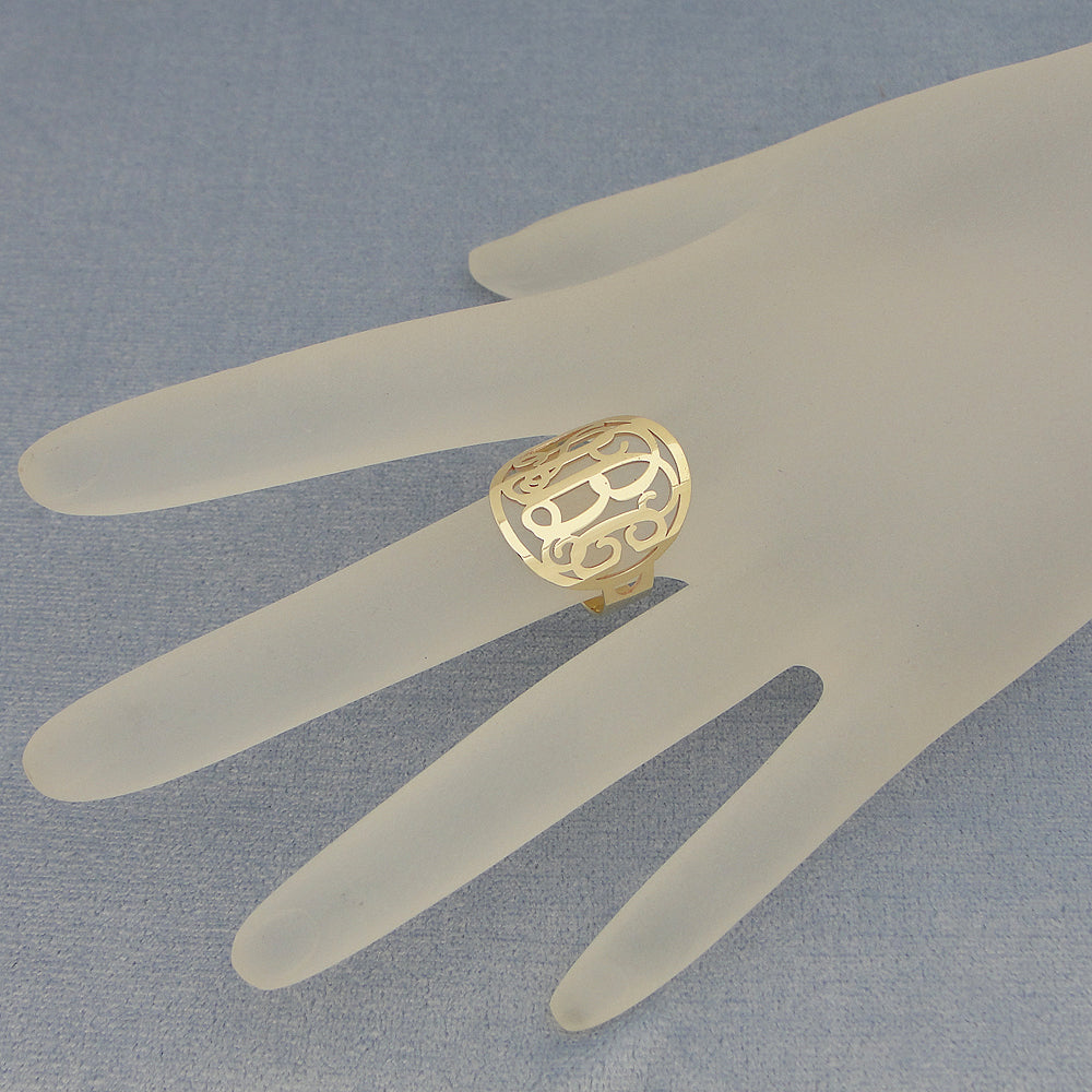 Custom personalized 3-letter gold circle monogram signet ring worn on hand