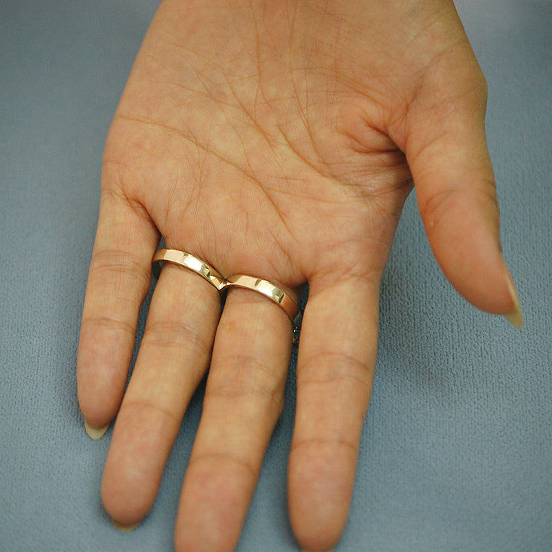 Model wearing custom solid gold Lauren Conrad two-finger name ring across fingers