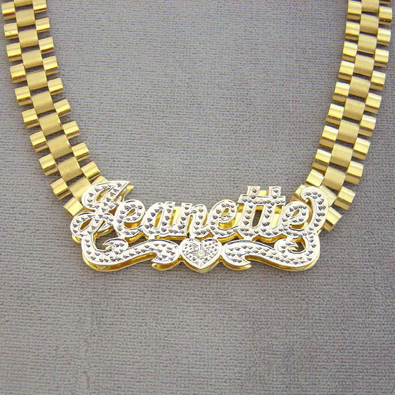 Hand-engraved 10K yellow gold 3D iced out custom nameplate reading Jeanette