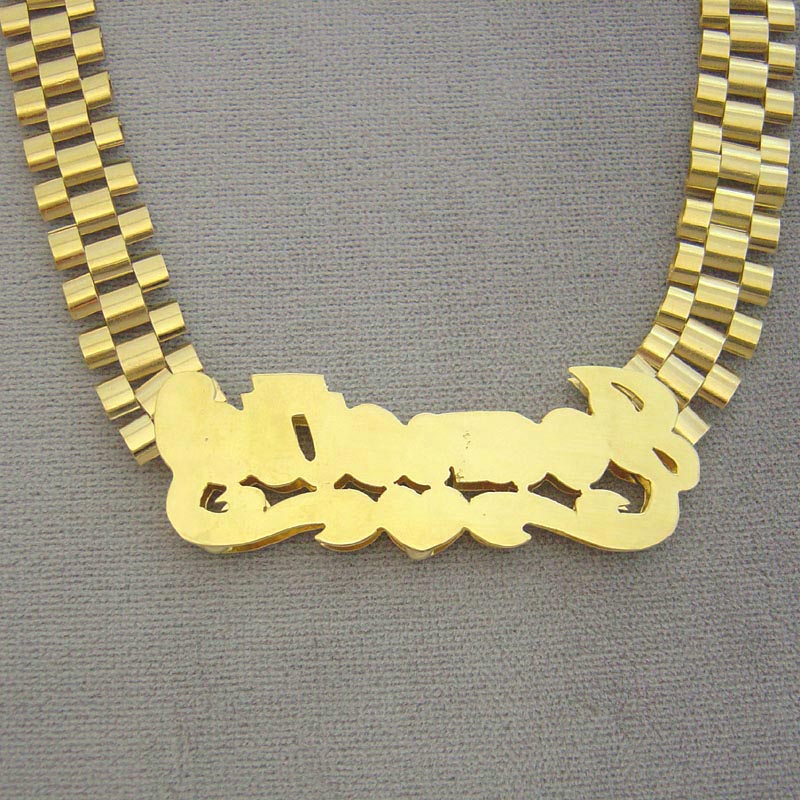 Custom 10K solid yellow gold 3D nameplate with back side view.