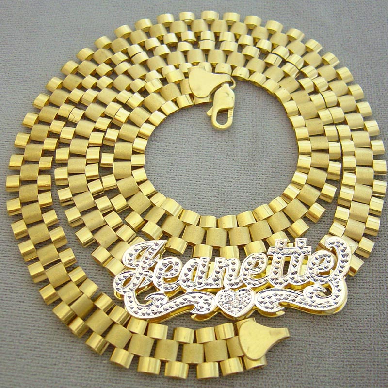 Close-up of handcrafted 10K yellow gold iced out nameplate necklace showing 10mm watch-band chain link detail
