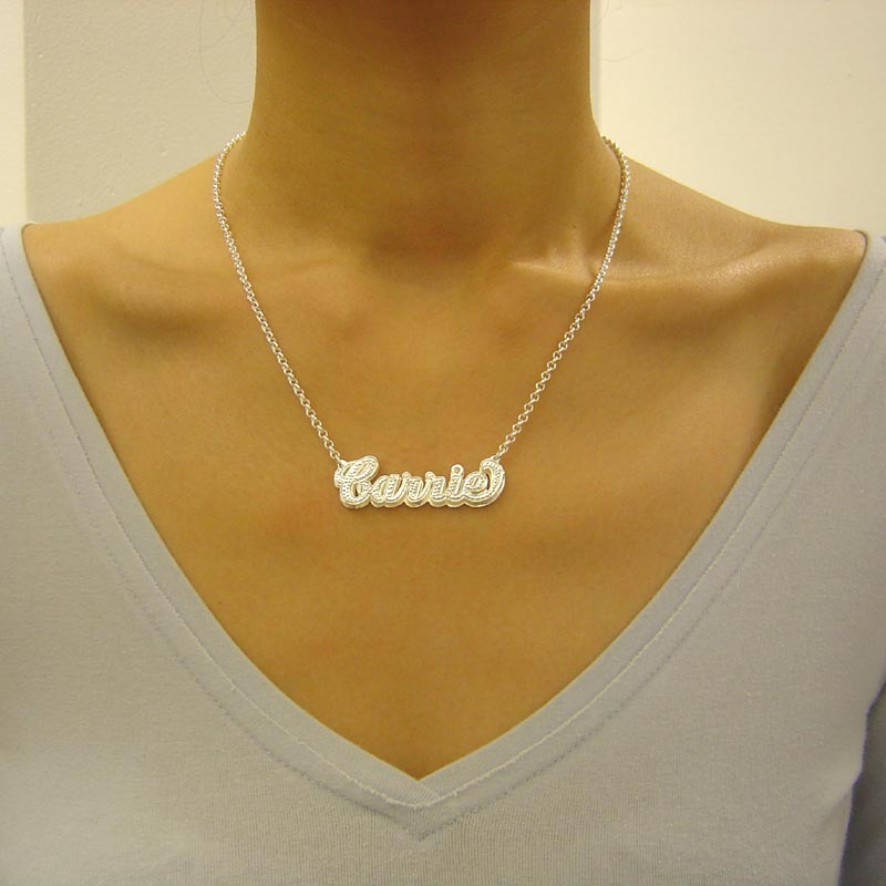 Custom sterling silver 3D cursive name necklace worn around the neck with a gold-tone top.