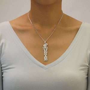 Model wearing a custom vertical silver name pendant reading "DENISE" on an 18-inch rolo chain.