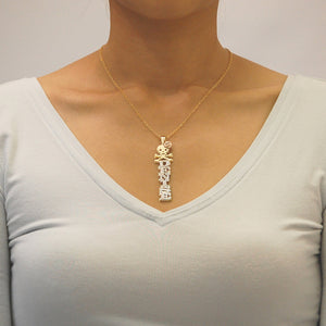 Model wearing the personalized gold 3D vertical skull and rose nameplate pendant layered on a solid gold chain.