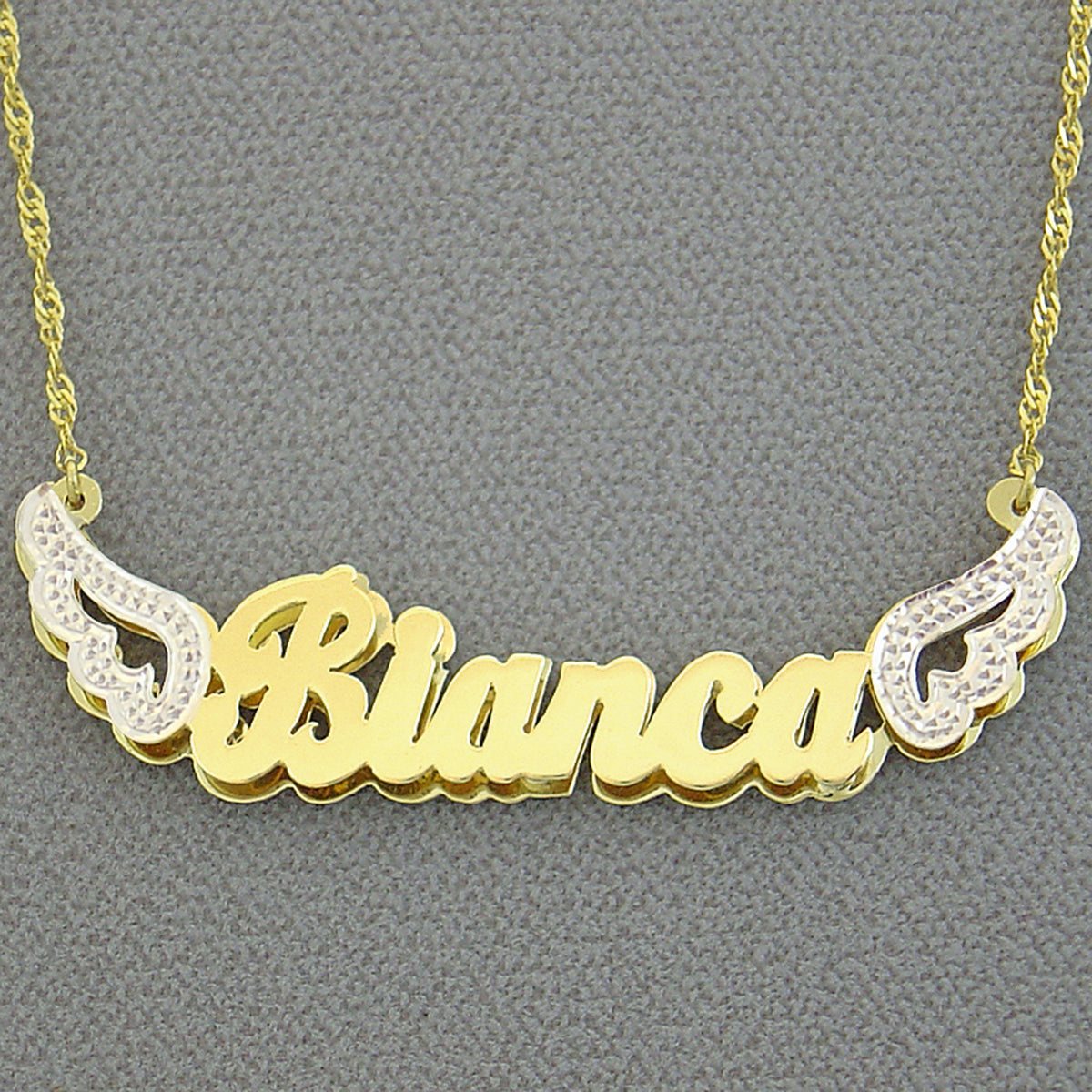 Custom solid gold angel wings 3D name pendant attached to a gold Singapore chain.