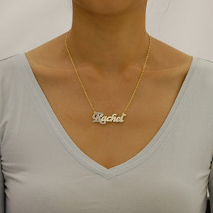 Model wearing a custom 10K two-tone solid gold double-plate script nameplate necklace.