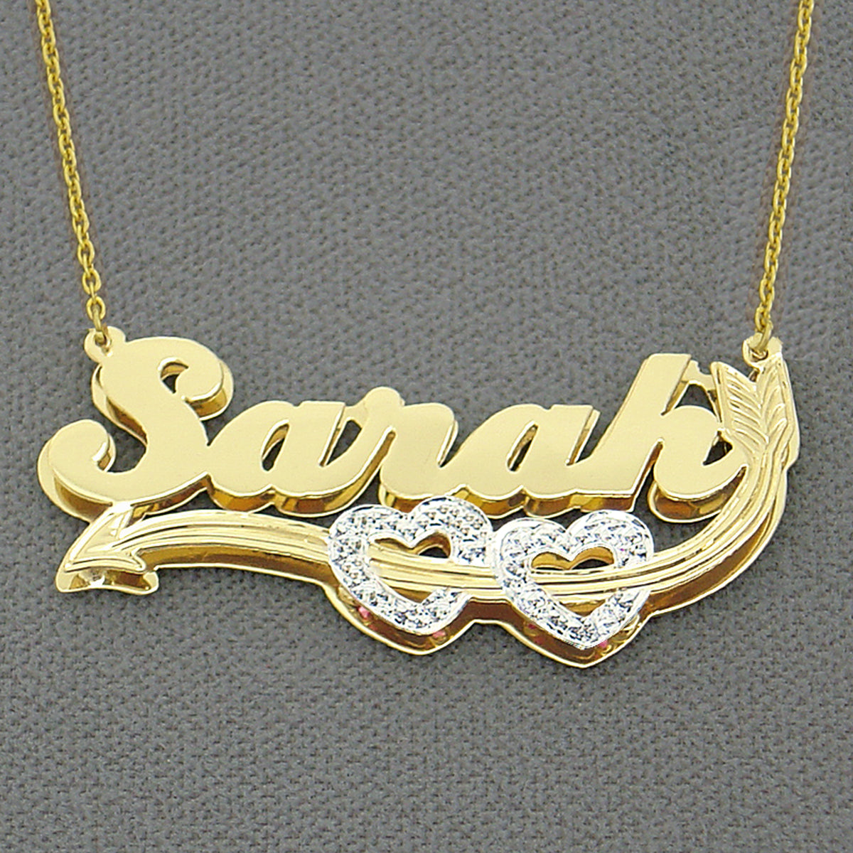 Personalized two-tone 3D gold name charm with hand-carved rhodium diamond-cut accents made in Los Angeles, USA.