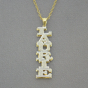 Close-up of hand-carved diamond-cut rhodium highlights on vertical gold nameplate.