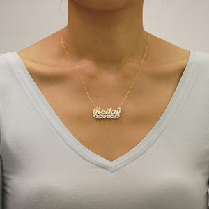Model wearing custom 10K gold 3D double plate nameplate necklace with 16-inch gold chain.
