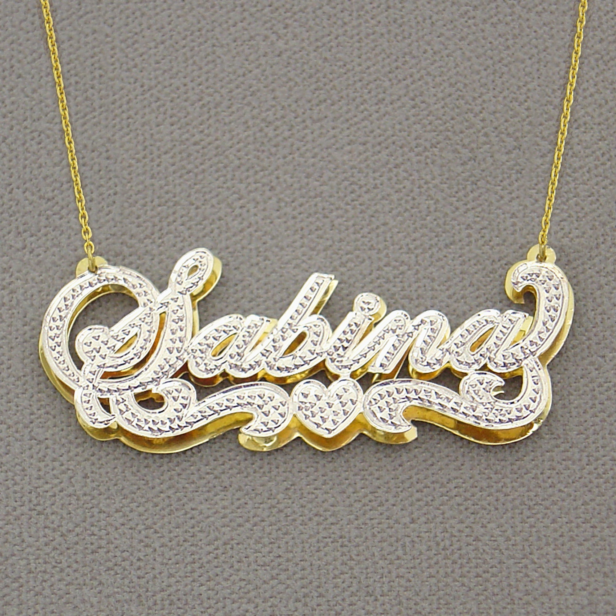 handcrafted 14K gold custom nameplate charm displaying solid backing construction