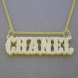 Close-up of custom iced-out gold nameplate pendant in Western cowboy font spelling Chanel.