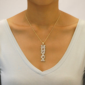 Model wearing 10K solid gold large vertical 3D name necklace with diamond accents