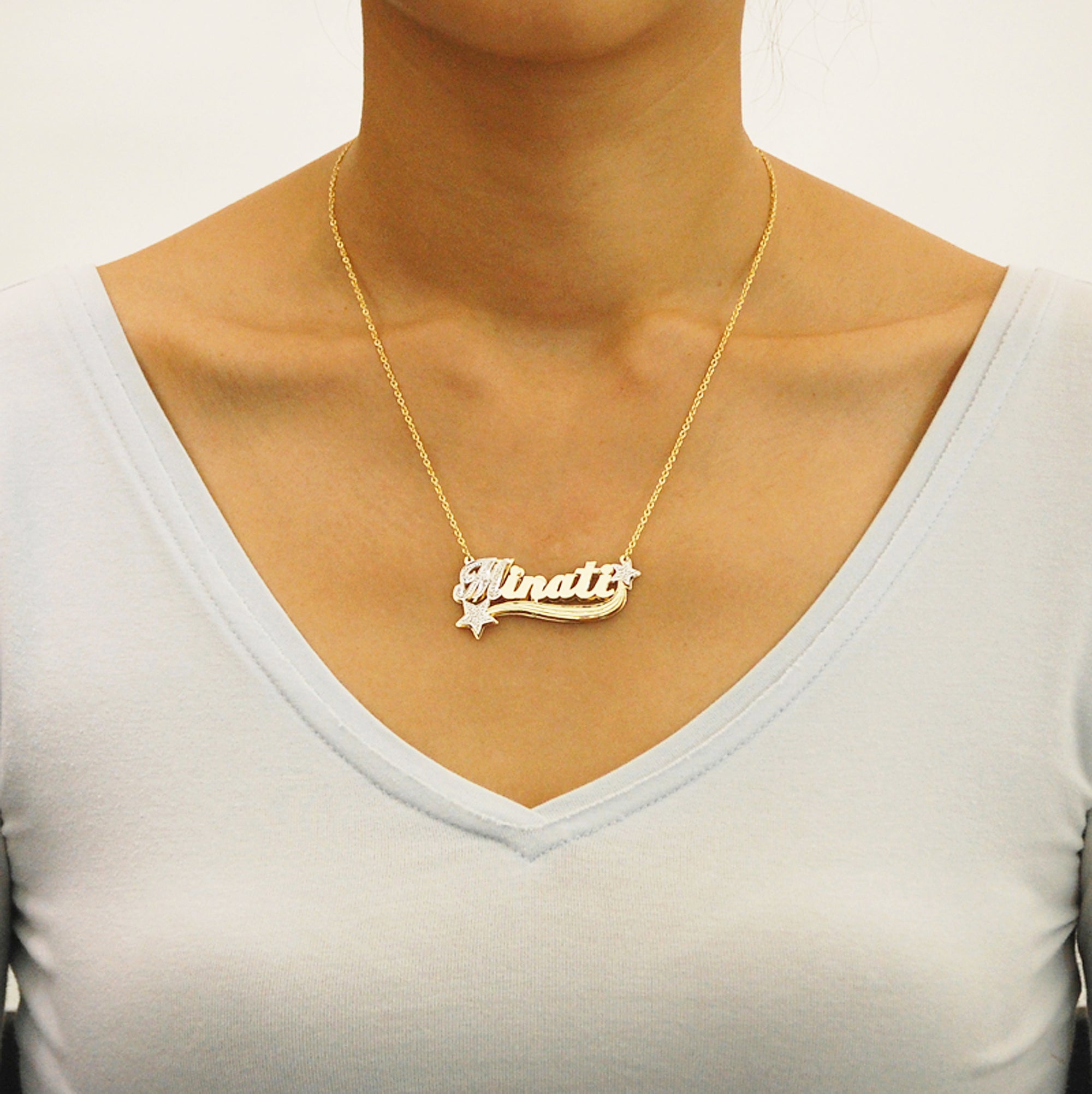 Model wearing a handcrafted solid gold 3D double-plate nameplate pendant necklace with diamond-accented star details.