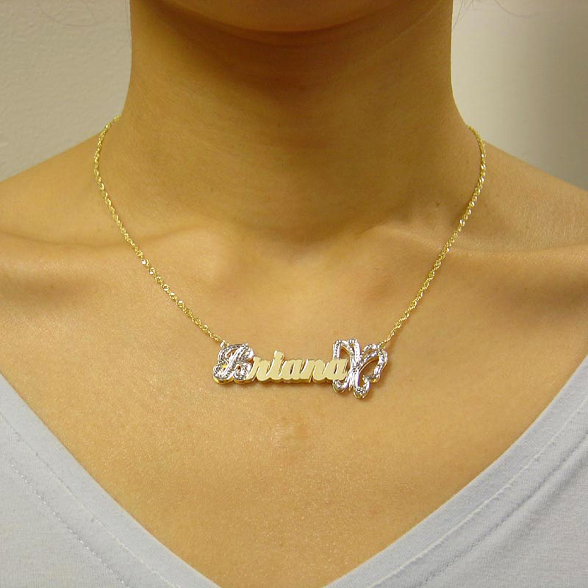Model wearing the personalized 3D gold butterfly nameplate pendant on a solid gold chain.