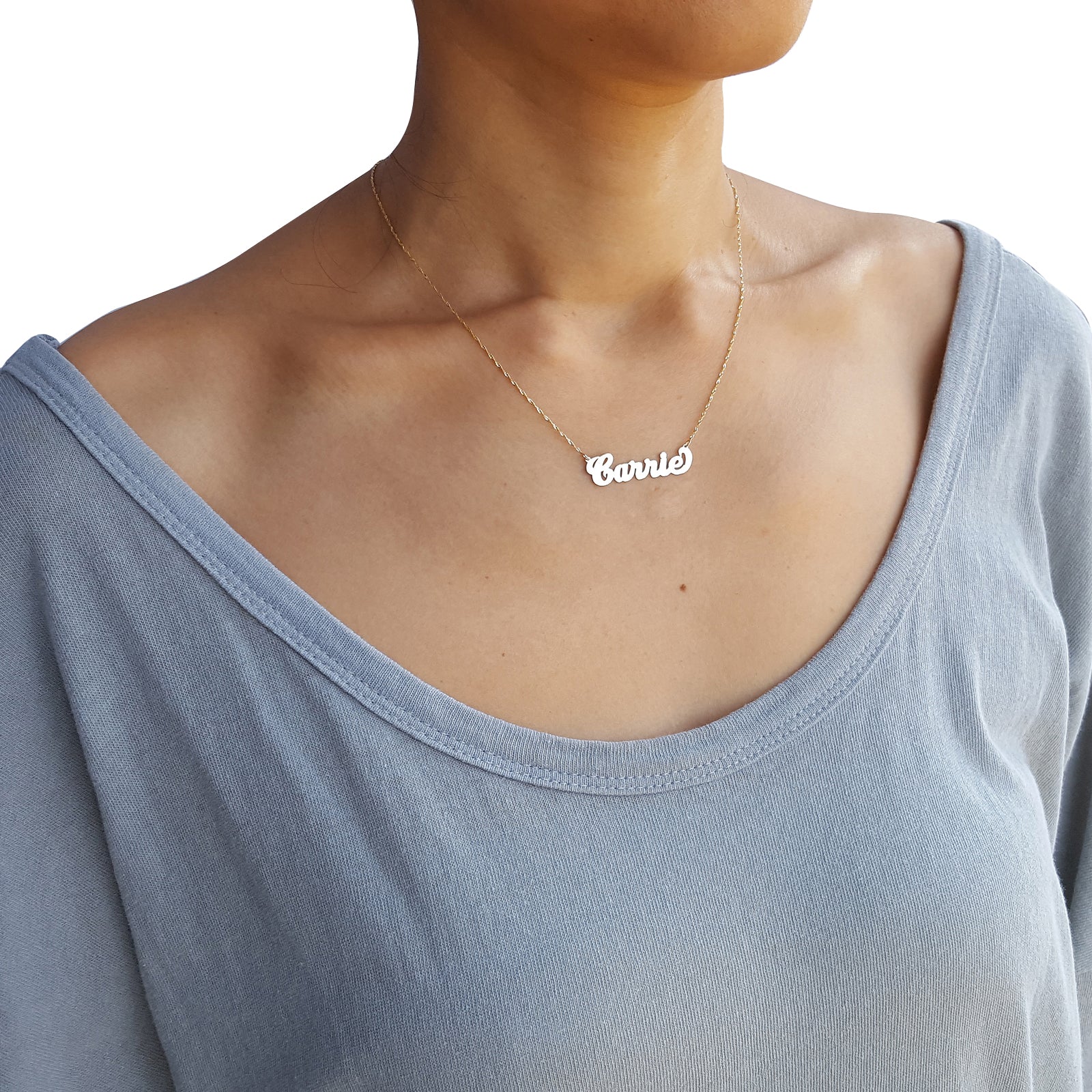 Personalized small 14k yellow gold Carrie style nameplate necklace featuring custom cursive script.