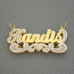 Close-up of hand-carved diamond accent detail and solid 10K or 14K yellow gold backing on custom 3D nameplate charm.