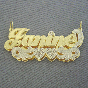 Angled close-up highlighting the diamond-cut rhodium finish and hand-carved bottom plate of the 3D name pendant.
