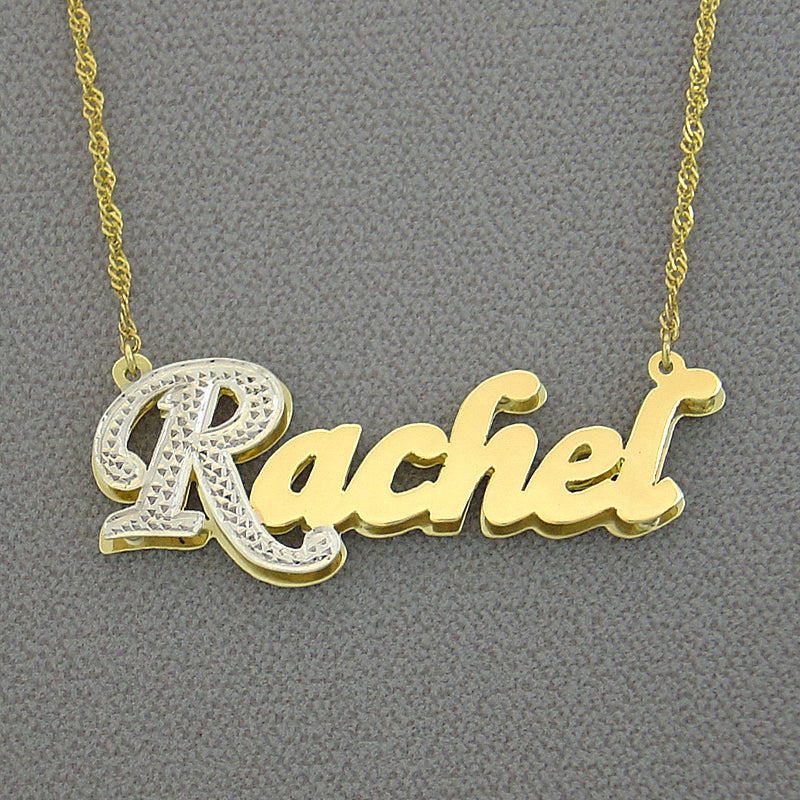 Close-up view of a personalized script nameplate pendant attached to a solid gold chain.