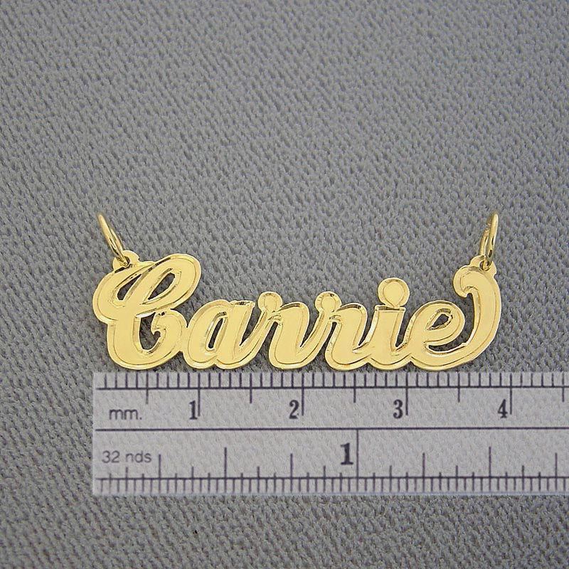 1.5 inch small solid gold custom cursive nameplate pendant on a textured background