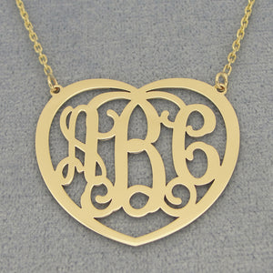 Close-up of a laser-cut 10k or 14k solid gold heart monogram pendant with three personalized initials.