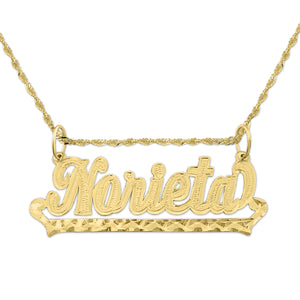 Close-up of a handcrafted 10k solid gold outlined cursive name pendant on a white background.