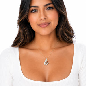 Woman wearing a 14K gold Old English initial S pendant necklace on a delicate gold chain.