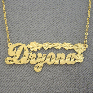 14K solid gold personalized name necklace featuring diamond-cut flower accents, custom made in script cursive for Dryana.