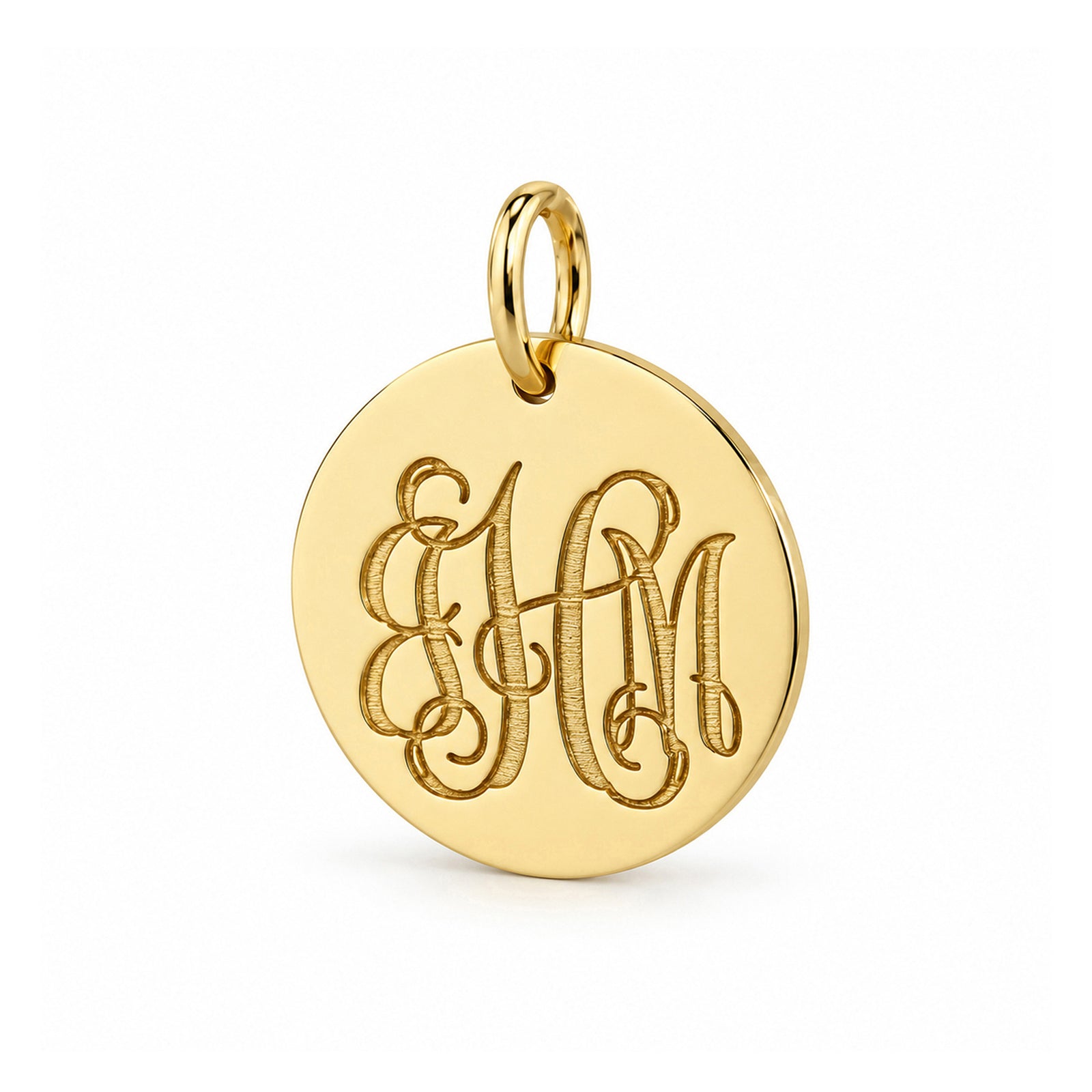Close-up of a polished 16 mm yellow gold disc pendant with three-initial monogram engraving and oval bail.