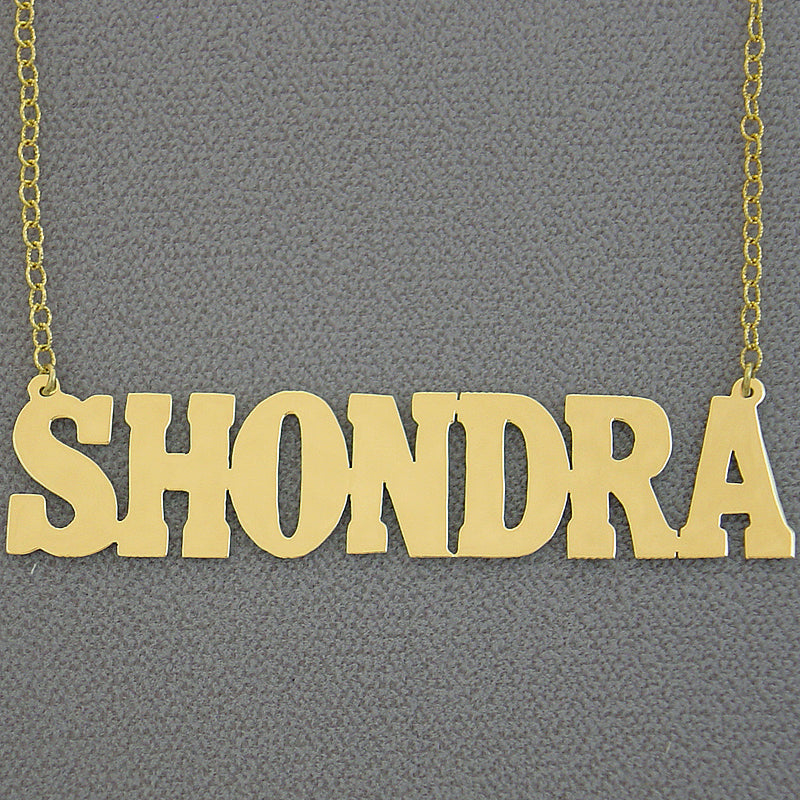 Custom 2.5-inch solid gold block letter nameplate necklace spelling out SHONDRA on a gold rolo chain.
