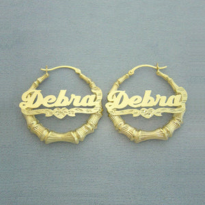 Solid 10k or 14k gold personalized bamboo hoop earrings featuring cursive name lettering and diamond cut heart accent