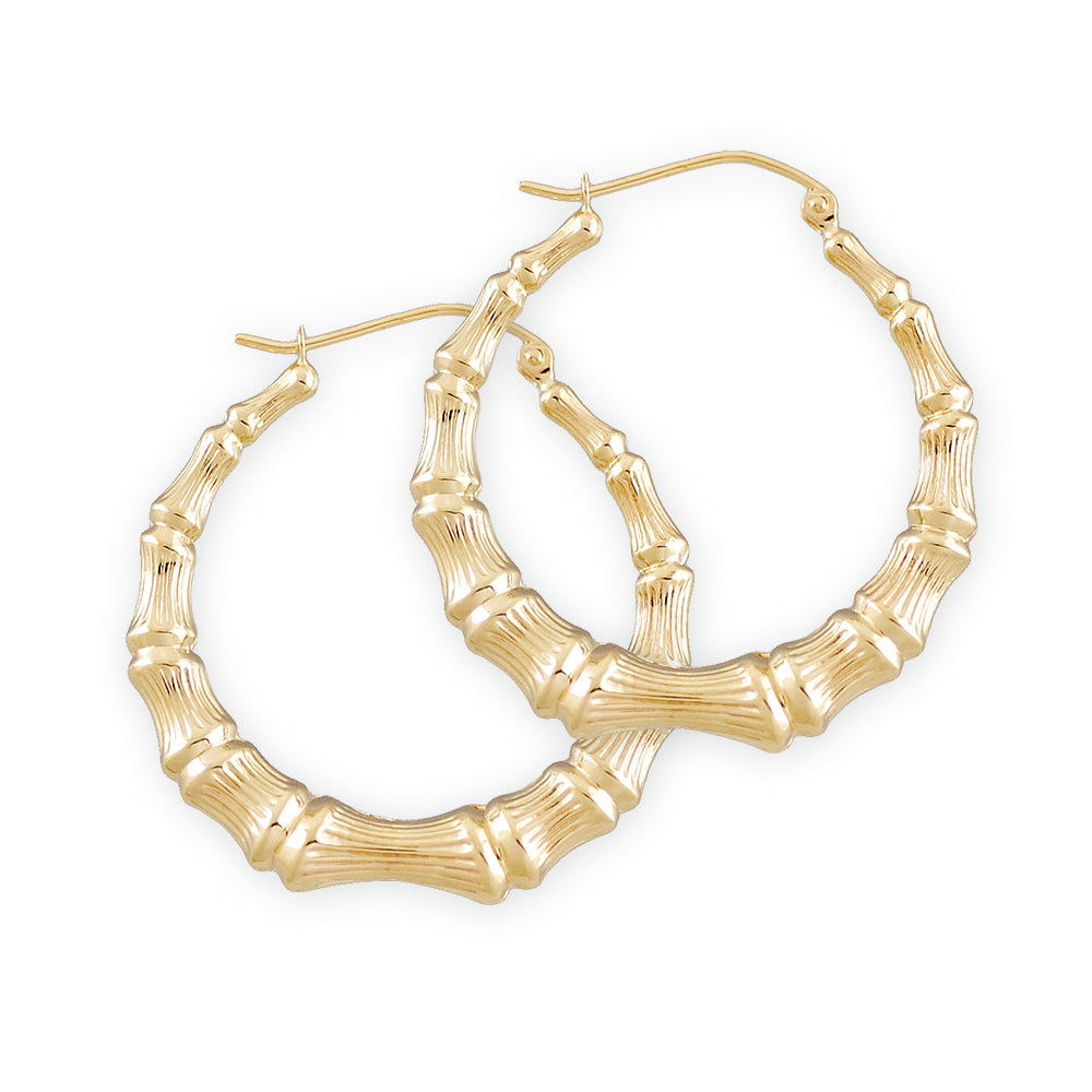 1 3/8 inch gold bamboo hoop earrings with a hollow design and clip closures.