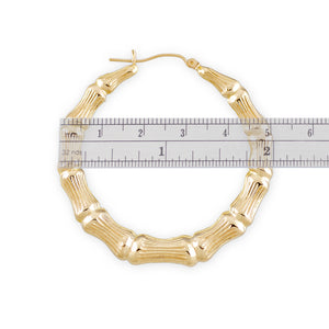 Close-up view of 10k yellow gold bamboo texture hoop earrings