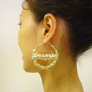 Model wearing 2 1/4 inch personalized gold bamboo hoop earrings with heart nameplate.