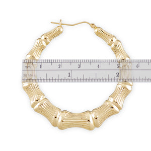 Detailed view of clip closure on 10k 14k yellow gold round bamboo hoop earrings