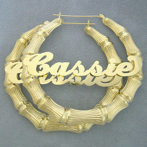 Custom 3-inch 10K gold bamboo hoop earrings featuring personalized cursive nameplate Cassie