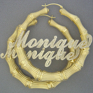 Custom 10k or 14k two-tone gold iced-out bamboo name hoop earring featuring Monique in cursive font